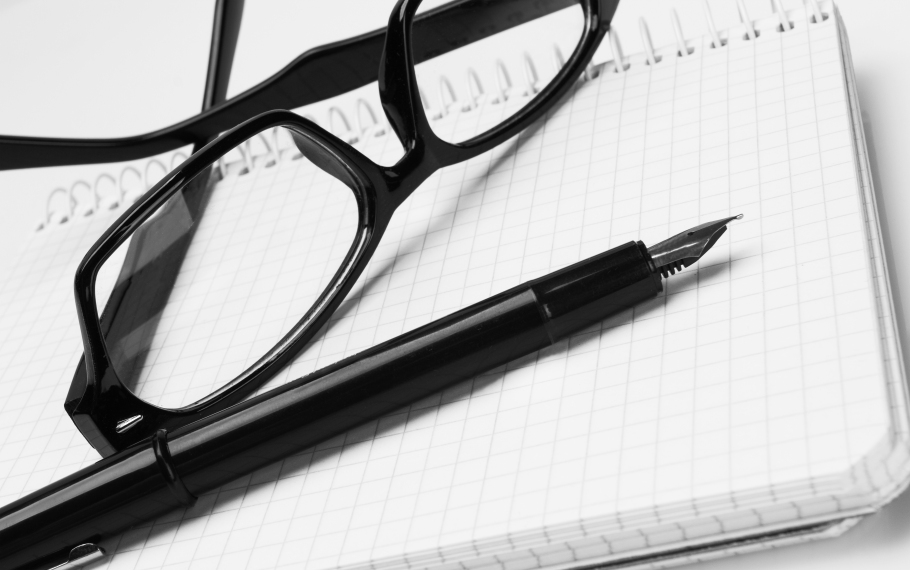 eyeglasses and pen on notepad